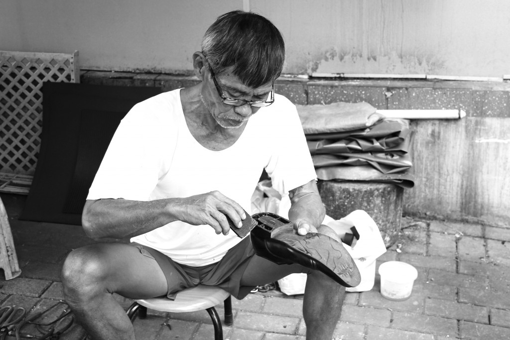 A long-time cobbler in Chinatown, Mr. Kwek, who is in his 60s.