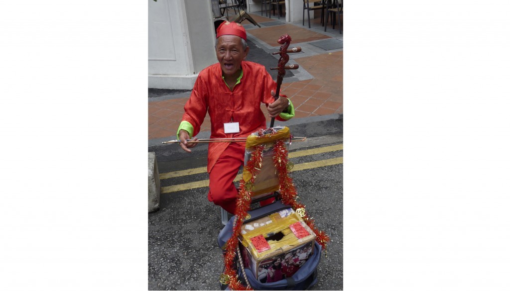 This erhu player always has a cheerful greeting for passersby.